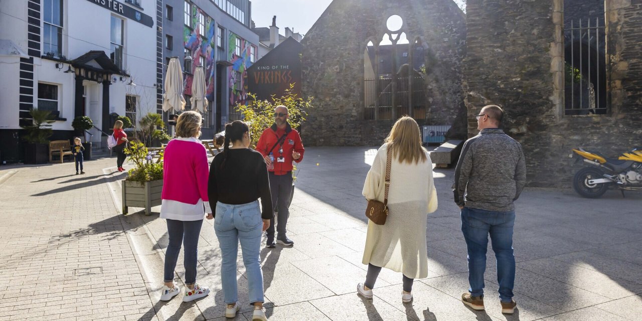 Tour guide in city centre with customers 
